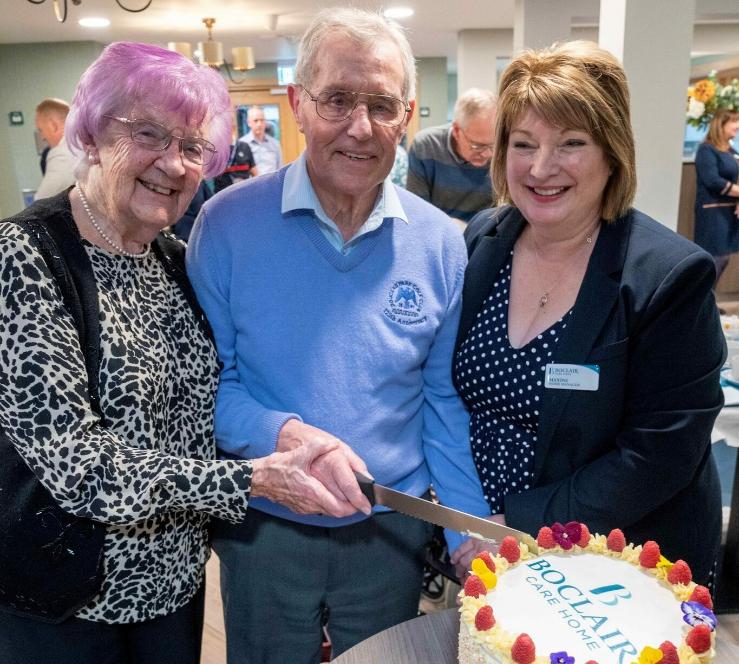 residents-cutting-the-cake-for-grand-opening