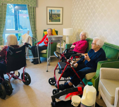 Residents relaxing with tea and biscuits after an engaging creative session.