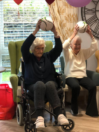 residents with footballs raised over their heads