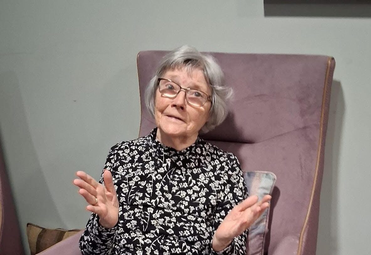 elderly care home resident in armchair