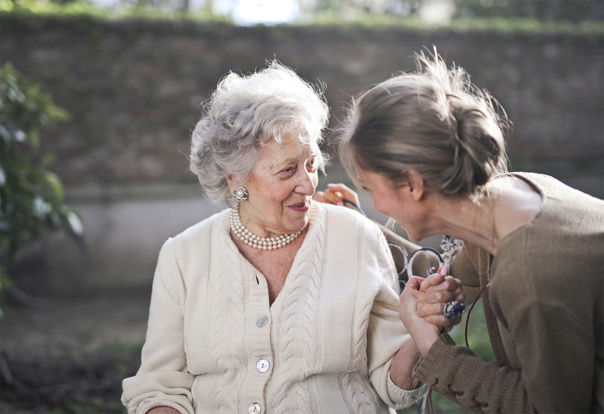elderly woman smiling with a care worker