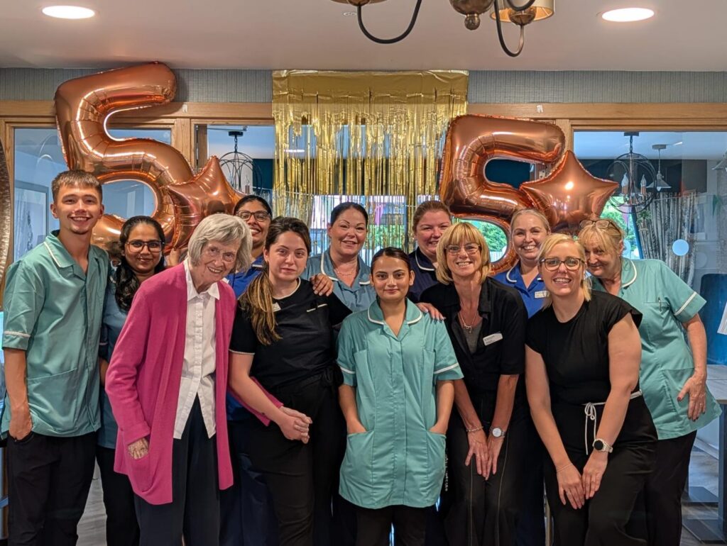 staff and residents celebrating with balloons
