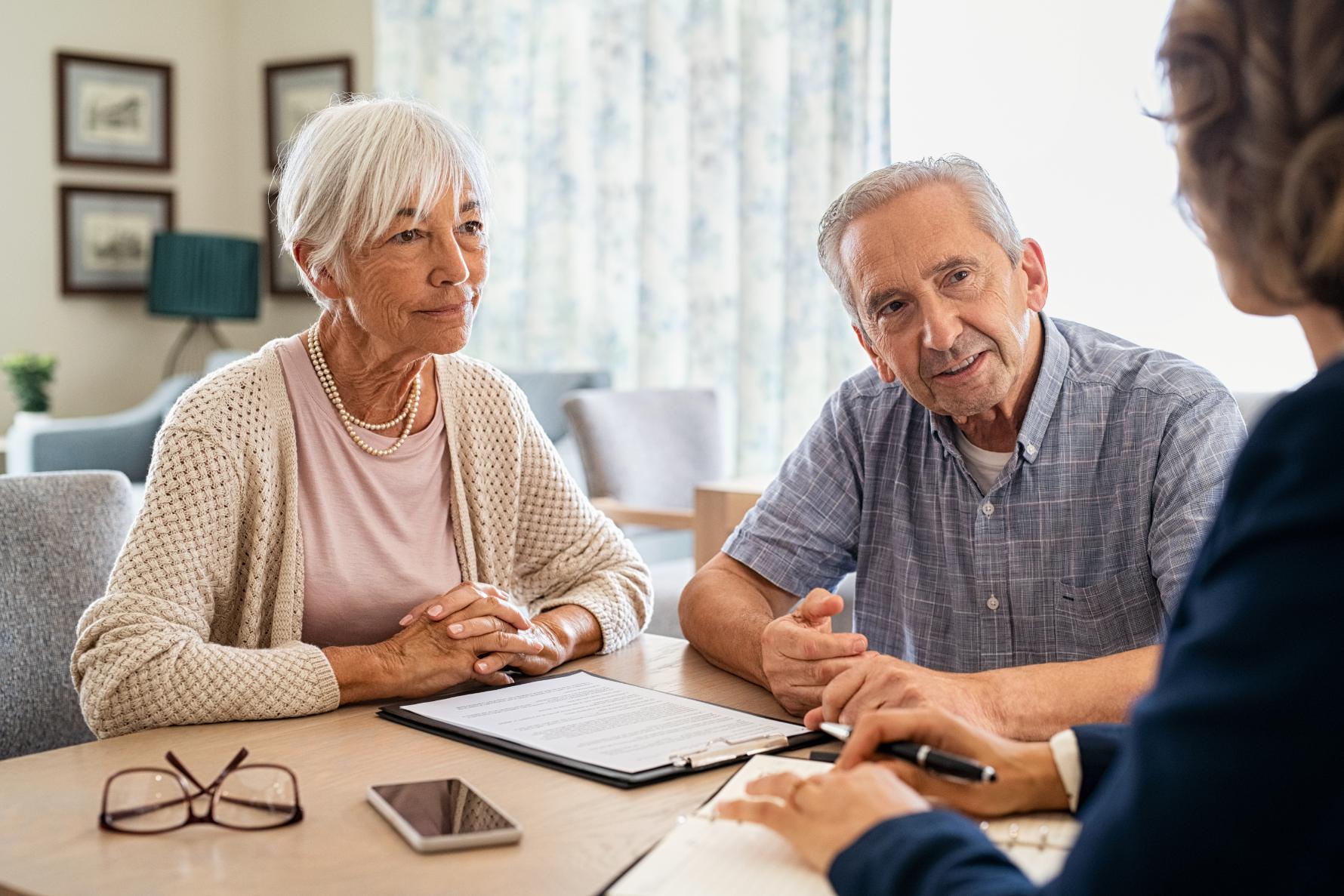 an elderly couple discussing care options with a care home